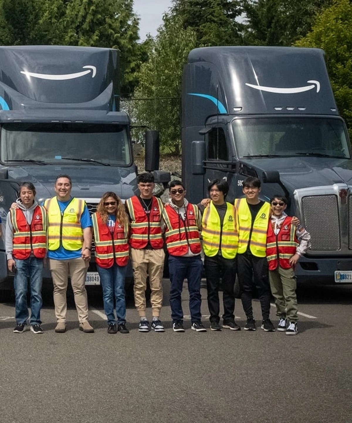 Poseidon Distribution team in safety vests in front of Amazon trucks